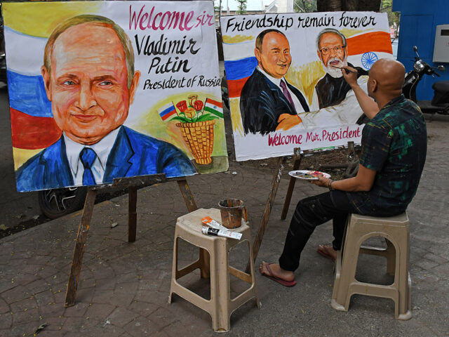 MUMBAI, MAHARASHTRA, INDIA - 2025/12/03: A teacher from Gurukul school of art paints a pos
