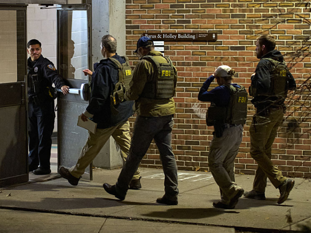 FBI agents enter the Barus & Holley building, home to the engineering and physics departme