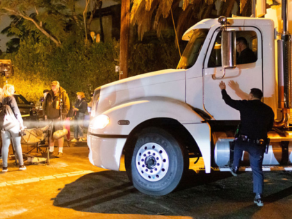 A police officer re-directs a truck driver near Rob Reiner's residence Sunday, Dec. 14, 20