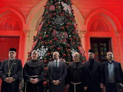 LATAKIA, SYRIA - DECEMBER 15: People gather for the lighting of the Christmas tree at the