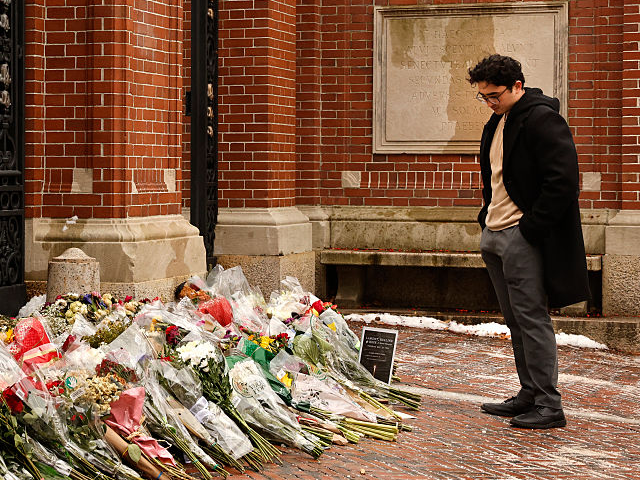 Providence, RI - December 17: A student stands at the Van Wickle Gates of Brown University