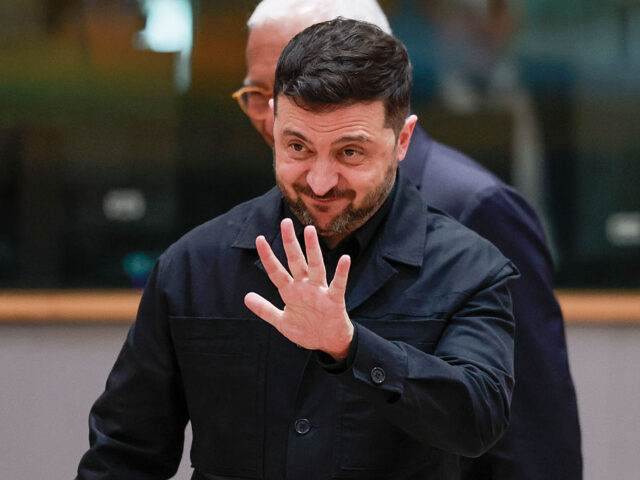 Ukrainian President Volodymyr Zelensky waves as he attends a EU summit in Brussels on Dece