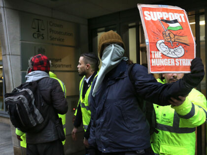LONDON, ENGLAND -DECEMBER 18: An activist holds a sign saying 'Support The Hunger S