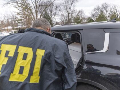 BLOOMINGTON, UNITED STATES - DECEMBER 18: Federal agents inspect the back of a vehicle con