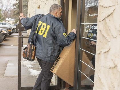 BLOOMINGTON, UNITED STATES â" DECEMBER 18: Federal agents enter an office building as a s