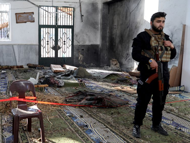 GettyImages-2252844711 Armed security officers cordon off the area following an explosion inside Imam Ali ibn Abi