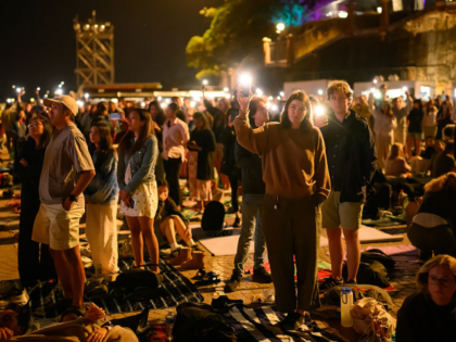 SYDNEY, AUSTRALIA - DECEMBER 31: People at Opera House turn on the flashlight on their pho