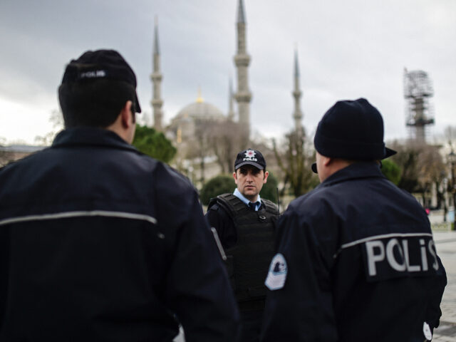 TOPSHOT - Turkish police officers stand guard near the Blue Mosque in Istanbul's tourist h