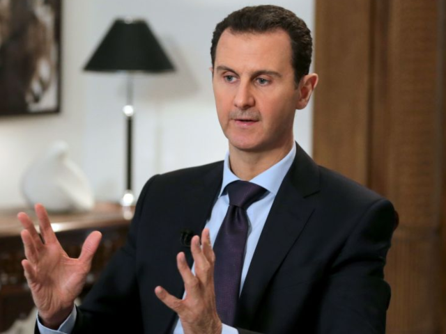 GettyImages-509761580 TOPSHOT - Syrian President Bashar al-Assad gestures during an exclusive interview with AFP