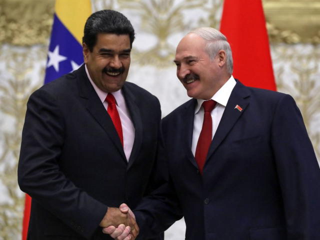 Belarus' President Alexander Lukashenko (R) shakes hands with his Venezuelan counterpart N