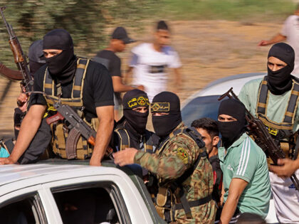 Palestinian militants move towards the border fence with Israel from Khan Yunis in the sou