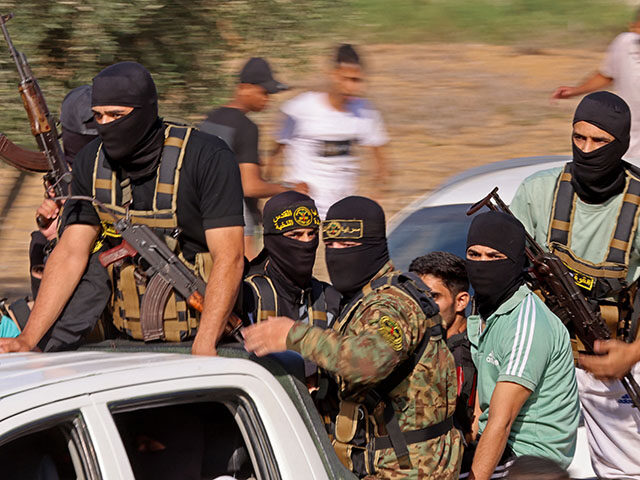 Palestinian militants move towards the border fence with Israel from Khan Yunis in the sou