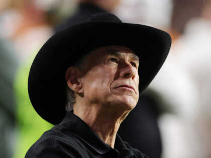 Texas Governor Greg Abbott looks on from the sidelines during the third quarter of a game