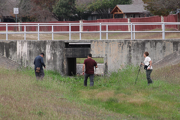 Searchers move slowly along a drainage creek looking for missing girl. (Randy Clark/Breitbart Texas)