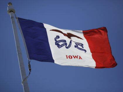The Iowa state flag flies outside the State Capitol Building in Des Moines, Iowa, U.S., on