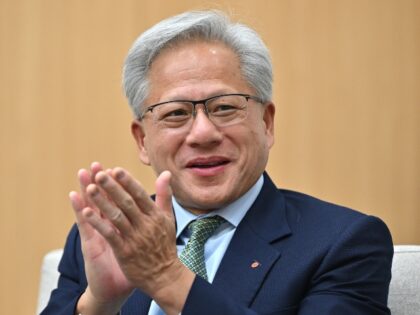 Jensen Huang claps in support of Donald Trump