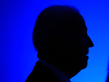 Former President Joe Biden listens to a speaker before receiving the Lifetime Achievement