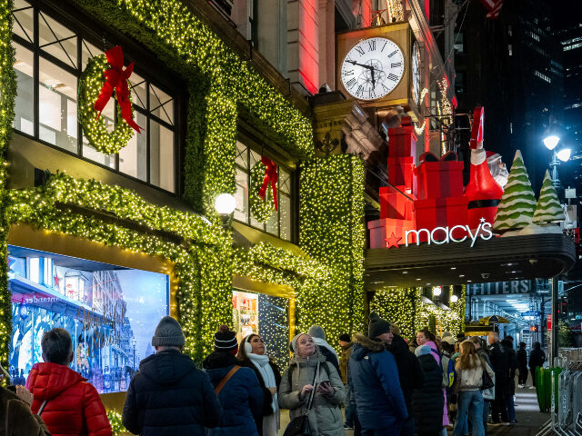 Macy's Shoppers wait in line outside of Macy's flagship store in Herald Square before openin