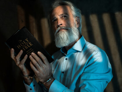 Man in prison with Bible