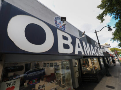 An Obamacare sign is displayed outside an insurance agency on November 12, 2025 in Miami,