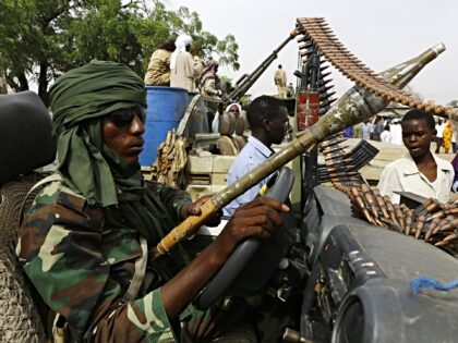 TO GO WITH AFP STORY BY TOM LITTLE A fighter from the Sudanese Rapid Support Forces sits i