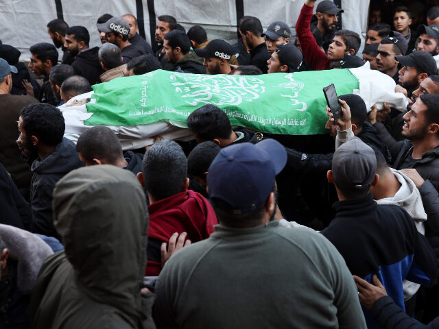 Senior Hamas Commander Eliminated Palestinians carry the bodies of two Hamas fighters, wrapped in the movement's flag,