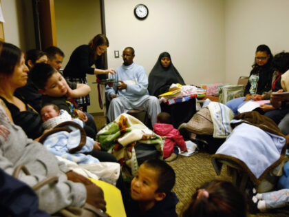 Abdi Mohammed, an immigrant from Somalia, completes forms ahead of a newborn care class at
