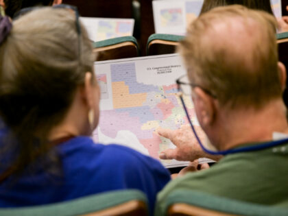 Attendees view a map during a Senate Special Committee on Congressional Redistricting publ