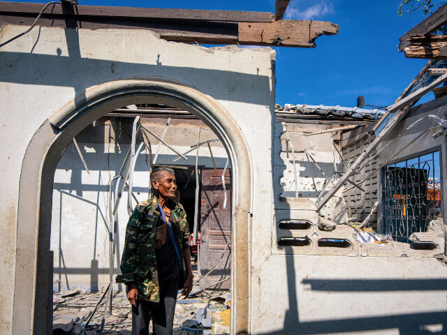 Thaland Cambodia conflict A resident shows part of a house, believed to have been damaged by Cambodian artillery she