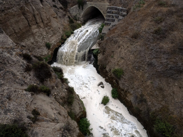 This aerial view shows a treated wastewater river heading to the Pacific Ocean near Real D