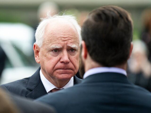 Tim Walz MINNEAPOLIS, MINNESOTA - JUNE 28: Minnesota Gov. Tim Walz presents a Minnesota flag to the