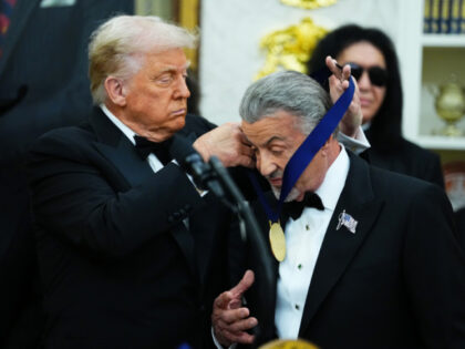 U.S. President Donald Trump (L) presents actor Sylvester Stallone (R) with a medal for the
