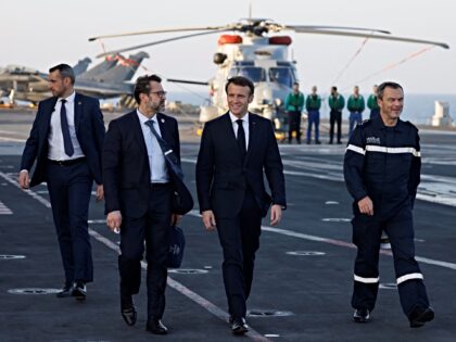 French President Emmanuel Macron arrives aboard the French aircraft carrier Charles de Gau