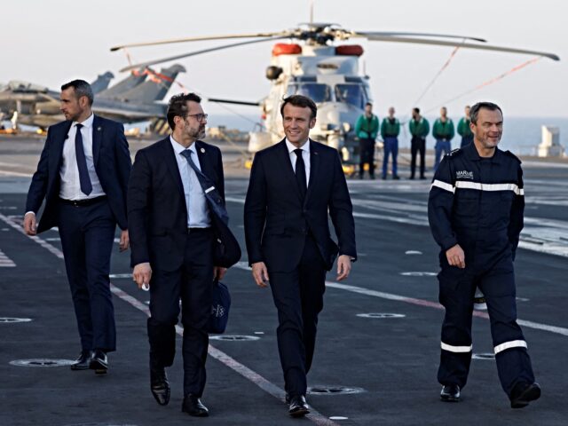 French President Emmanuel Macron arrives aboard the French aircraft carrier Charles de Gau
