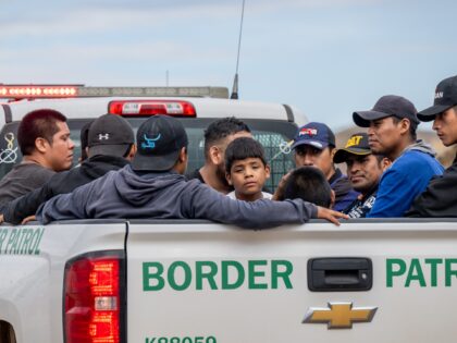 RUBY, ARIZONA - JUNE 24: Migrants seeking asylum from Central and South America sit in the