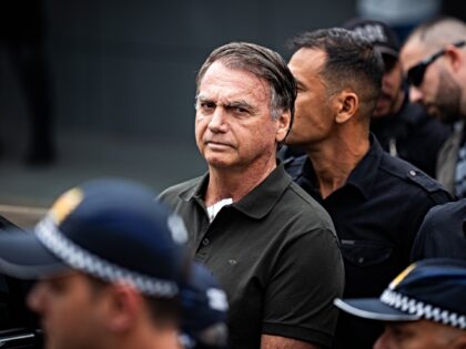Jair Bolsonaro, Brazil's former president, center, departs from a scheduled surgery at the