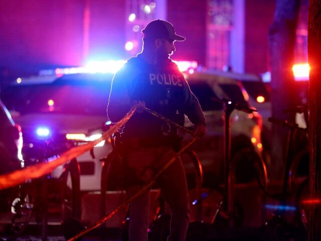 brown-university-shooting-plice-tape-AP A police officer hangs yellow crime tape at Brown University in Providence, R.I., on Satur