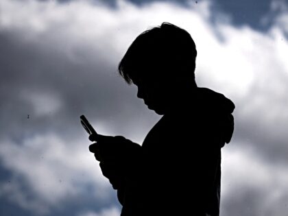 children bots This photo taken on October 24, 2025 shows a 14-year-old boy posing at his home near Gosfo