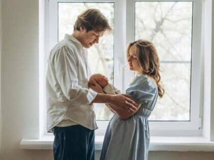 father and mother with newborn baby