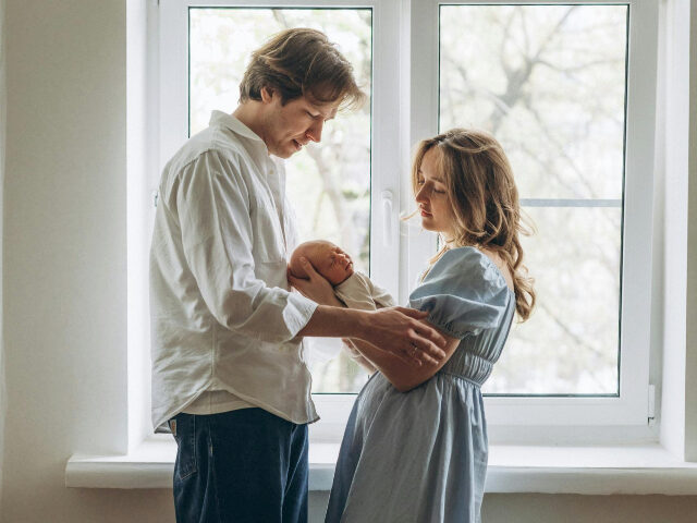 father and mother with newborn baby