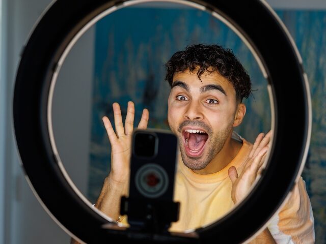 goofy guy filming a TikTok video