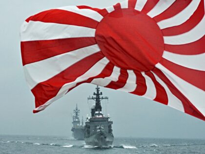 The flag of the Japanese Maritime Self-Defense Force (MSDF) flutters in the wind while MSD