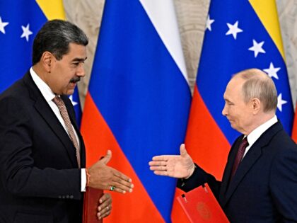 Russian President Vladimir Putin and Venezuelan President Nicolas Maduro shake hands as th