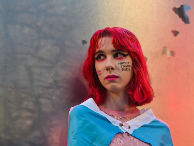A member of the public attends a candle-lit vigil at the Spire on O'Connell Street, i