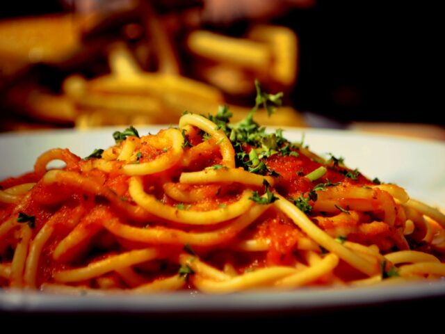 A plate of spaghetti with tomato sauce and parsley, Mandy Bourke via Unsplash
