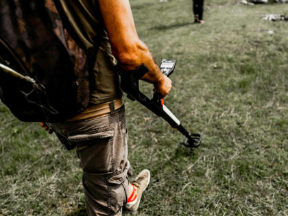 metal-detector-stock-pexels-cosmin-gavris Person with Metal Detector