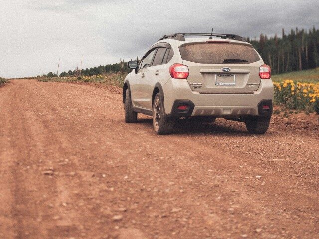 Subaru Crosstrek driving on road.