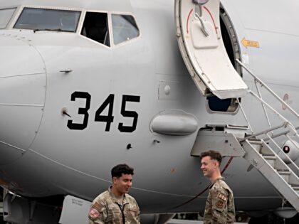 US Airforce personnel and a US Navy P-8 Poseidon aircraft during the Farnborough Internati