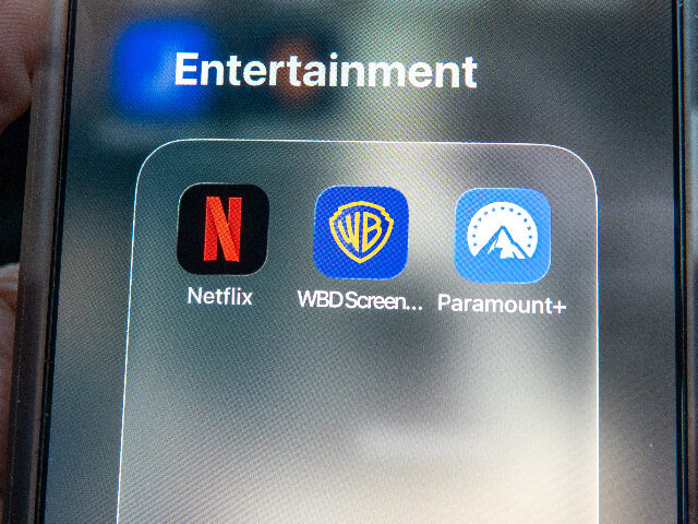 warnerbros BRISTOL, UNITED KINGDOM - DECEMBER 09: In this photo illustration a man holds a iPhone, th