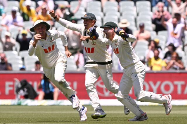 Australia's Marnus Labuschagne (L), Usman Khawaja (C) and Alex Carey (R) celebrate af